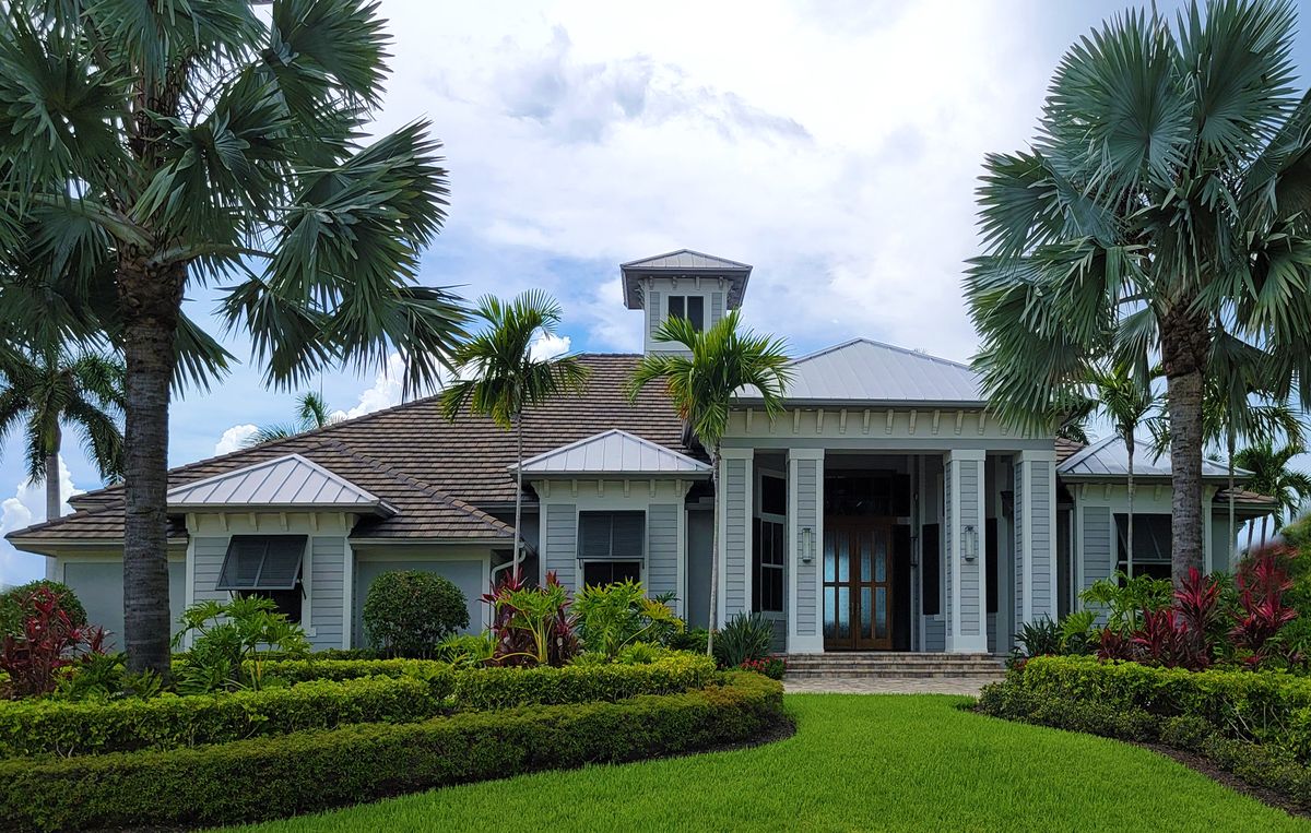 Florida home framed by palm trees and lawn